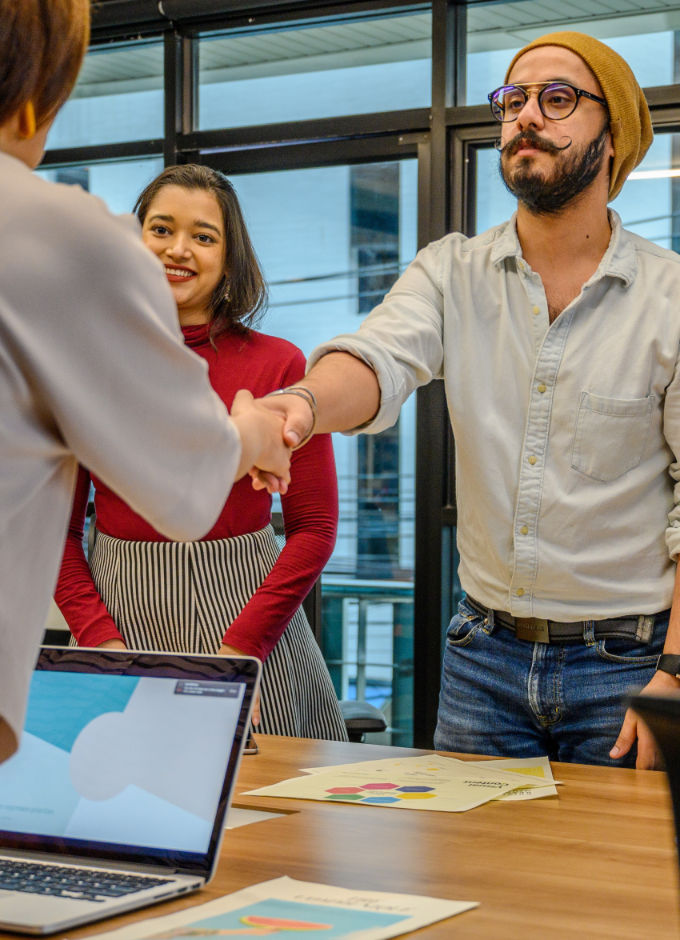 A man shaking hand with a woman during a job interview