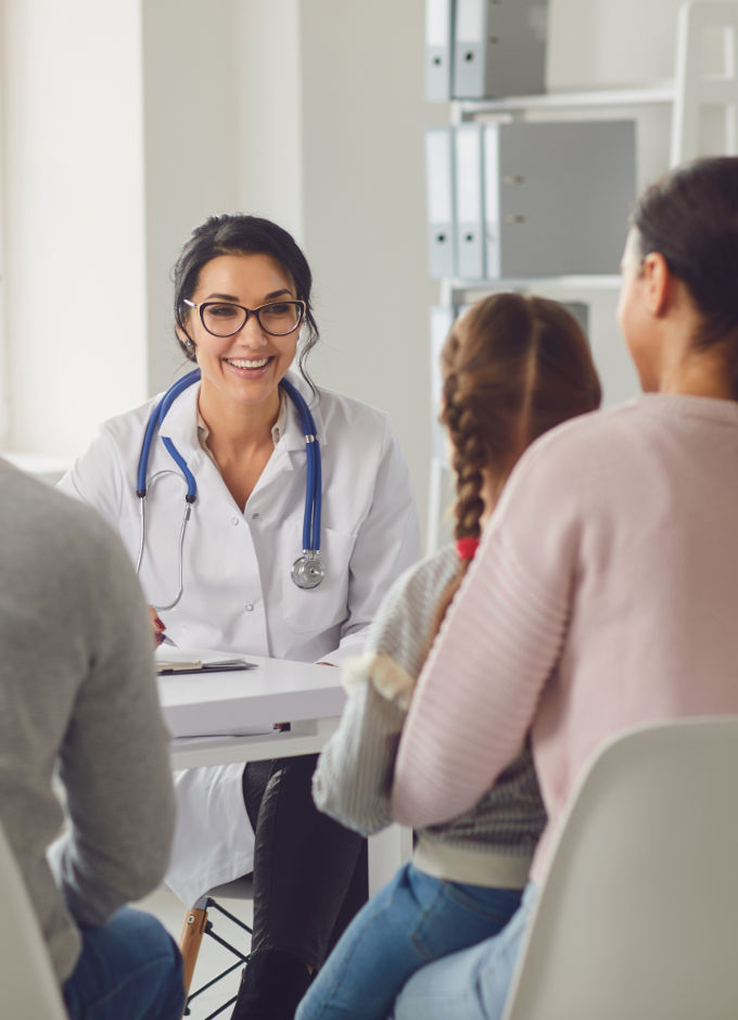 A doctor is talking to a family with a child